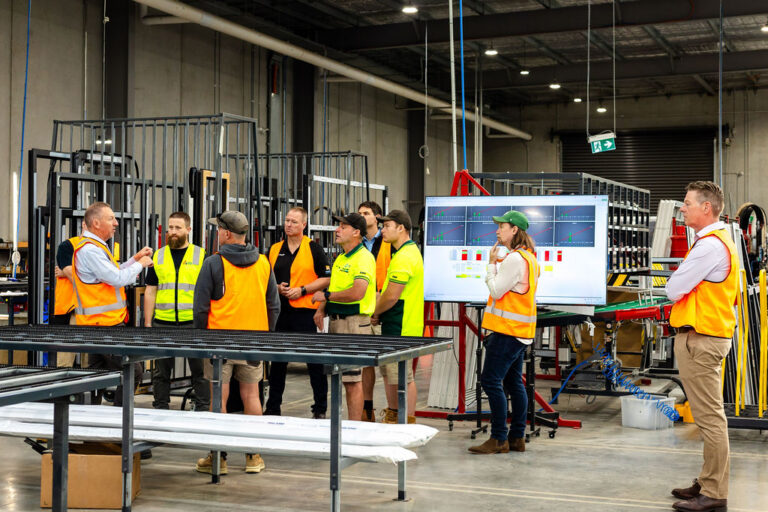 Perfect Windows and Doors workers showcasing the European Technology to builders on the factory floor.