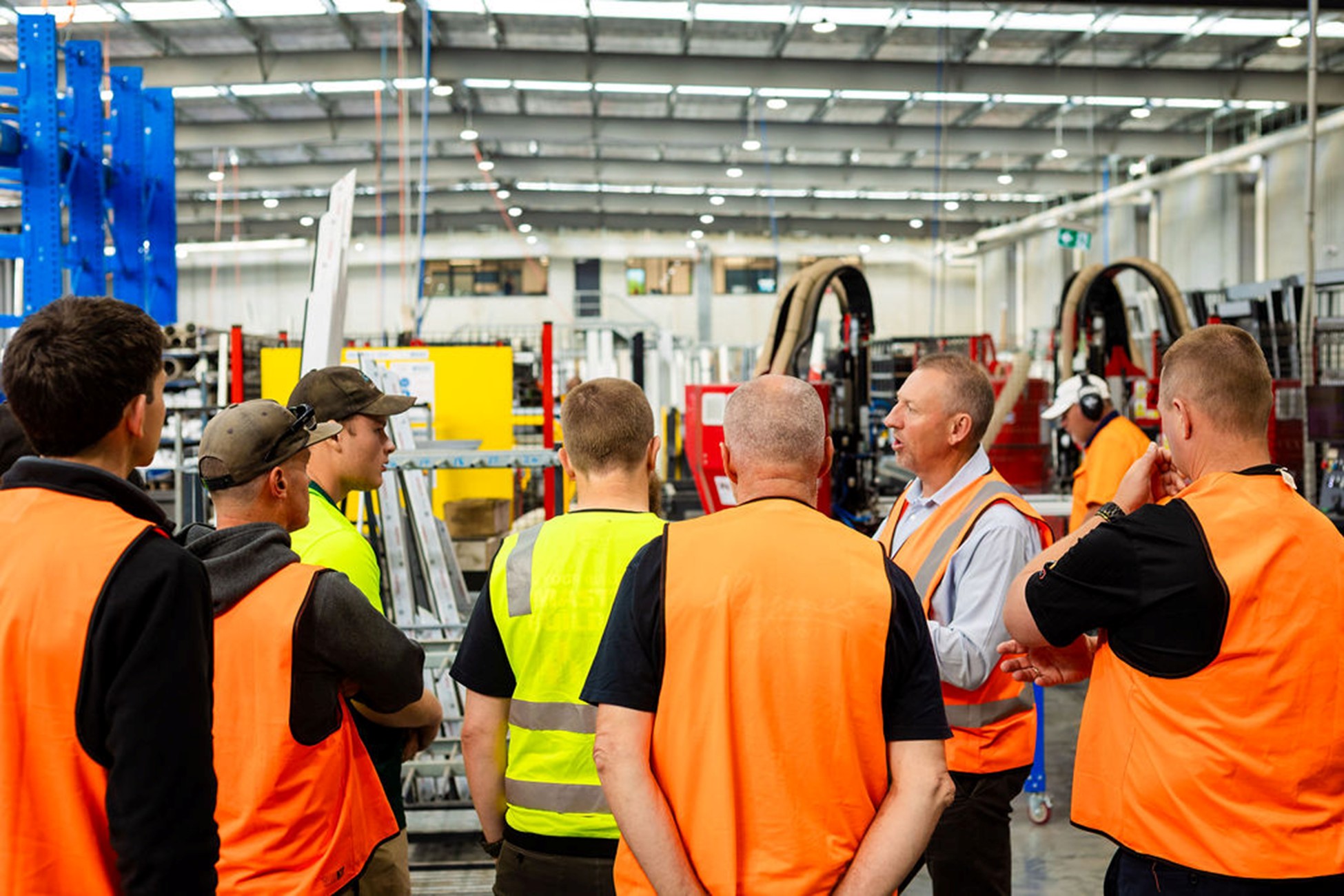 Perfect Windows and Doors workers showcasing the European Technology to builders on the factory floor.
